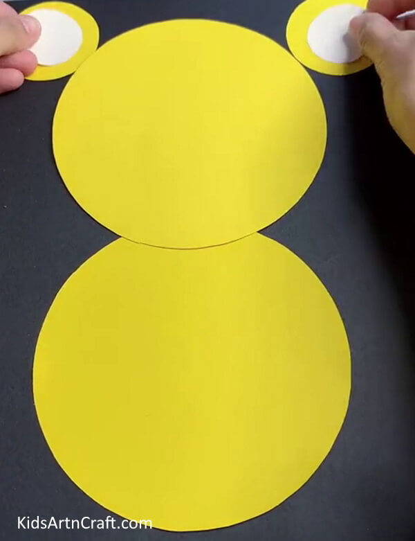 Pasting White Circle On Ears - A straightforward paper tiger craft idea for children. 