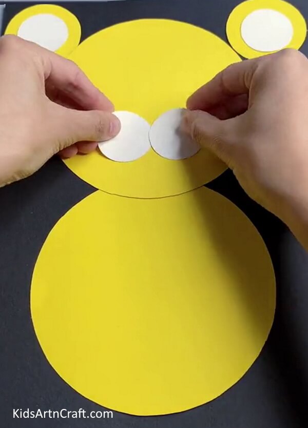 Pasting Two White Circles On the Face - A simple paper tiger craft for kids. 