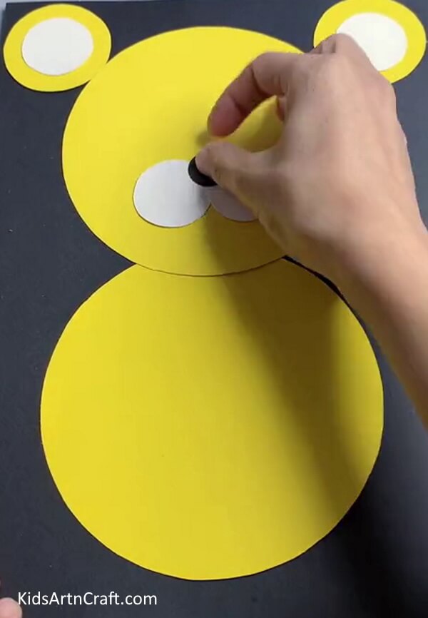 Pasting A Black Circle On the Nose - A paper tiger craft project that is easy to make for little ones. 
