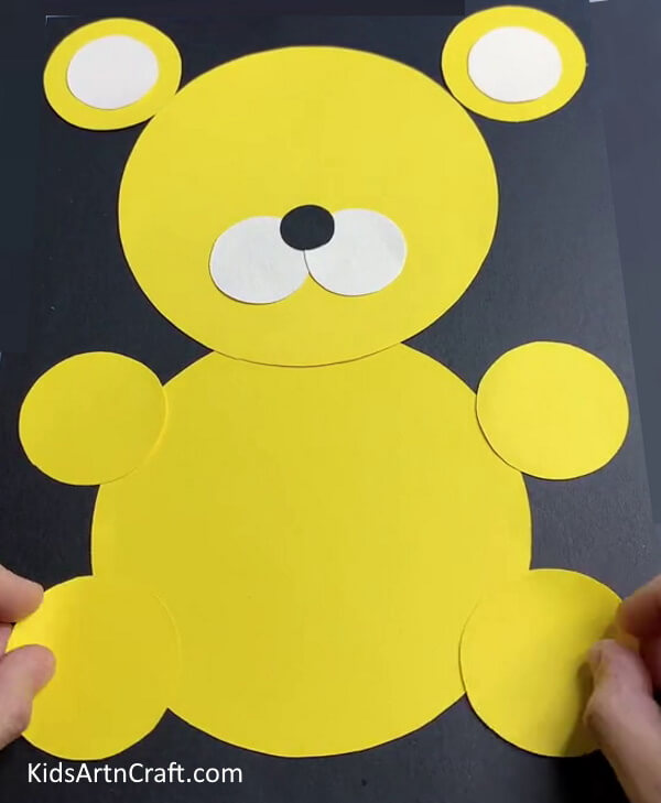 Pasting Yellow Circles To Make Legs - A paper tiger craft that is simple to create for children. 