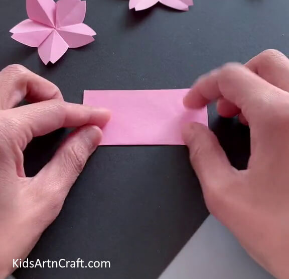 Folding Paper In Half - Step-by-step directions for making a beautiful Origami flower.