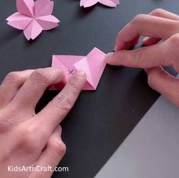 Folding Corners Of The Rectangle - Learn how to make a paper flower with this easy-to-follow tutorial.