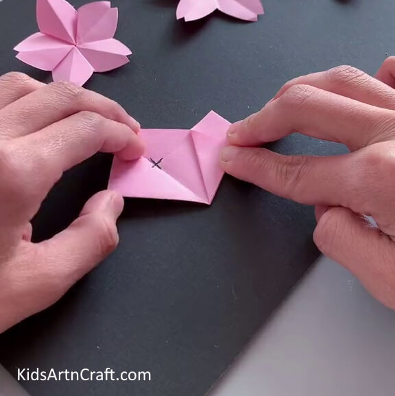 Folding Corner Back - Find out how to craft a gorgeous Origami flower with this helpful guide.