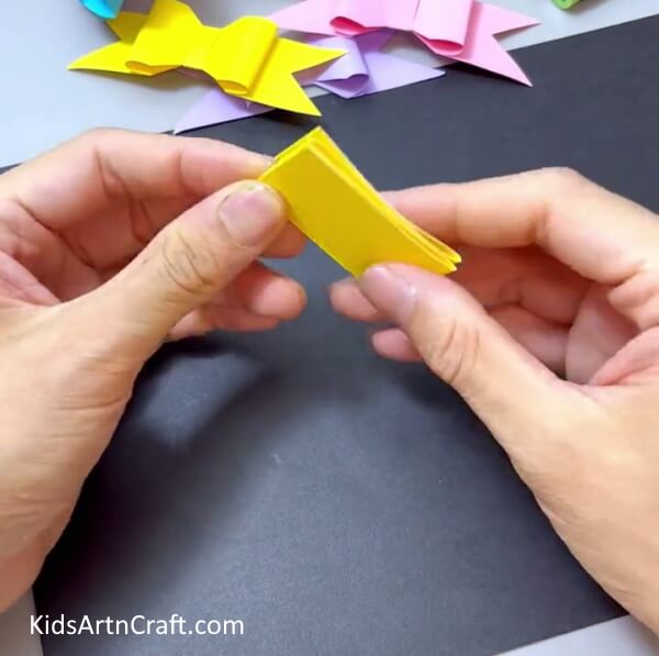 Folding The Other End In Half - Design a Quick Paper Bow Activity for Youngsters