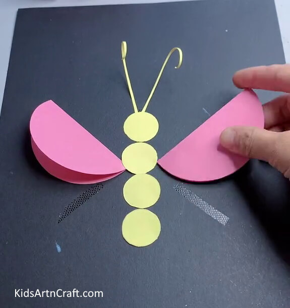 Pasting The Pink Circles - Making a Butterfly Out of Paper: A Guide for Kids