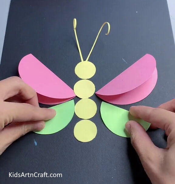 Pasting The Green Circles - Create a Paper Butterfly with This Easy Tutorial for Kids