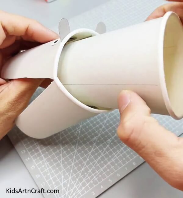 Inserting Another Paper Cup - Utilizing Recycled Paper Cups to Make a Creature Craft for Kids