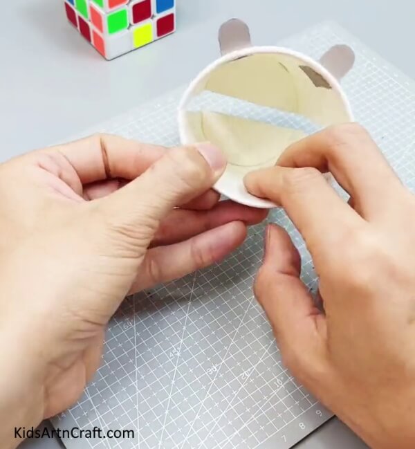 Pasting Paper Inside Cup - Crafting a Creature with Recycled Paper Mugs for Toddlers