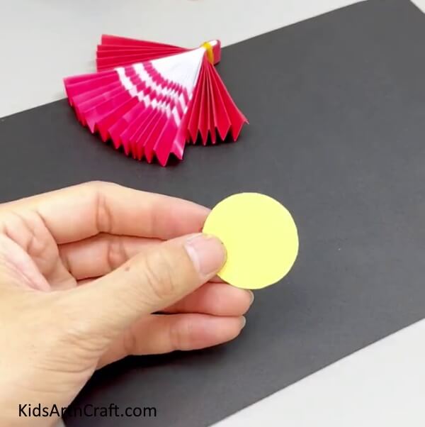 Cutting Out A Circle For The Face - Assembling a Paper Doll Craft For Little Ones
