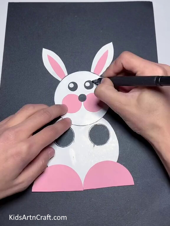 Drawing The Nose And Outlining The Eyes . Executing a straightforward paper bunny craft
