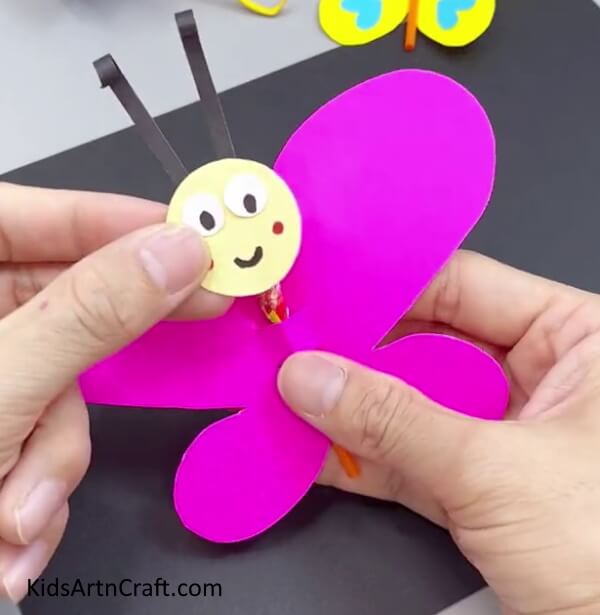 Pasting Face On Butterfly - Making a Paper Butterfly - Effortless Tutorials for Little Ones