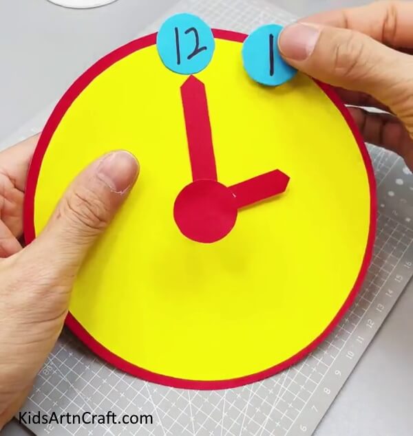 Pasting Numbers Of The Clock. - Stepwise guide to creating a paper clock with kids.