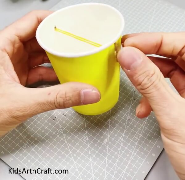 Securing The Ends With a Tape -Creating a rocket out of paper cups already in use for children. 