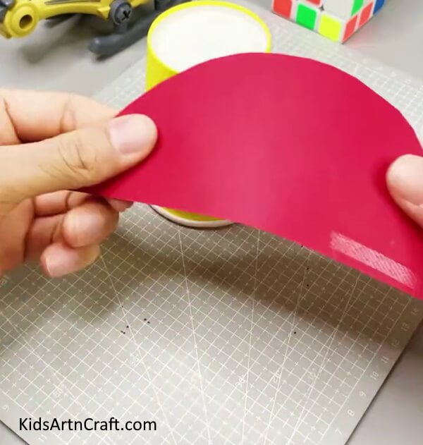 Cutting A Red Semicircle -A craft for youngsters using recycled paper cups to make a rocket. 