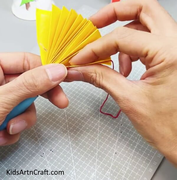 Pasting Thread On Fan - Producing a paper fan plaything craft for children to have fun with. 