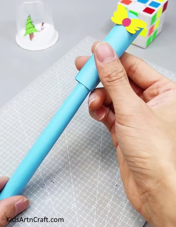 Bringing Paper Roll Down To See Magic - Assembling a paper fan toy craft for kids to enjoy.