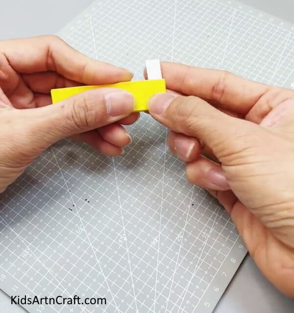 Applying Double Side Tape On the End Of the Fan - Crafting a Paper Fan Toy to Amuse Youngsters