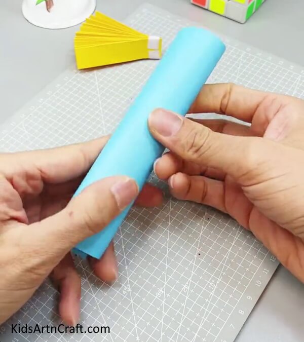 Rolling Paper To Form A Cylinder - Constructing an Amusing Paper Fan Toy for Kids to Enjoy