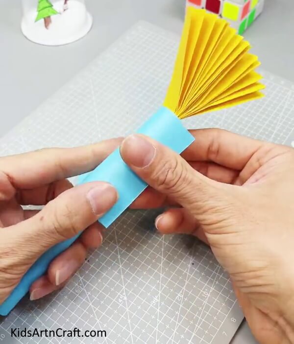 Rolling Another Blue Paper - Constructing a Fun Paper Fan Toy Craft for Kids to Play With