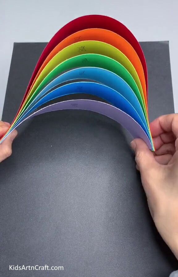 Folding The Strips To Get A Rainbow- Make a Colorful Cloud Decoration Using Paper Strands