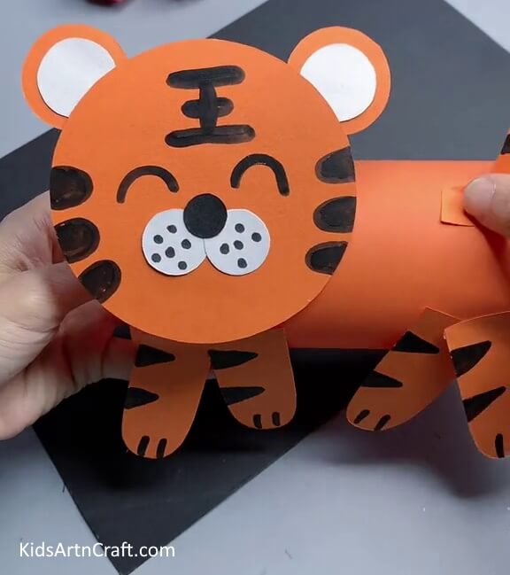 Pasting the Legs And Tail Of The Tiger - Putting Together a Paper Tiger as an Artistic Pursuit for Kids