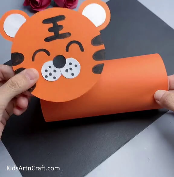 Pasting the Face Over the Cylindrical Body Of The Tiger - Forming a Paper Tiger as a Child-Friendly Activity