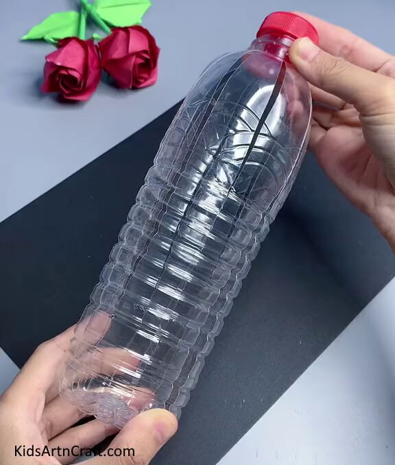 Removing The Cap Of The Bottle And Pushing The Strips Back - Reusing Plastic Bottles To Create Bee Art - A How-To Tutorial
