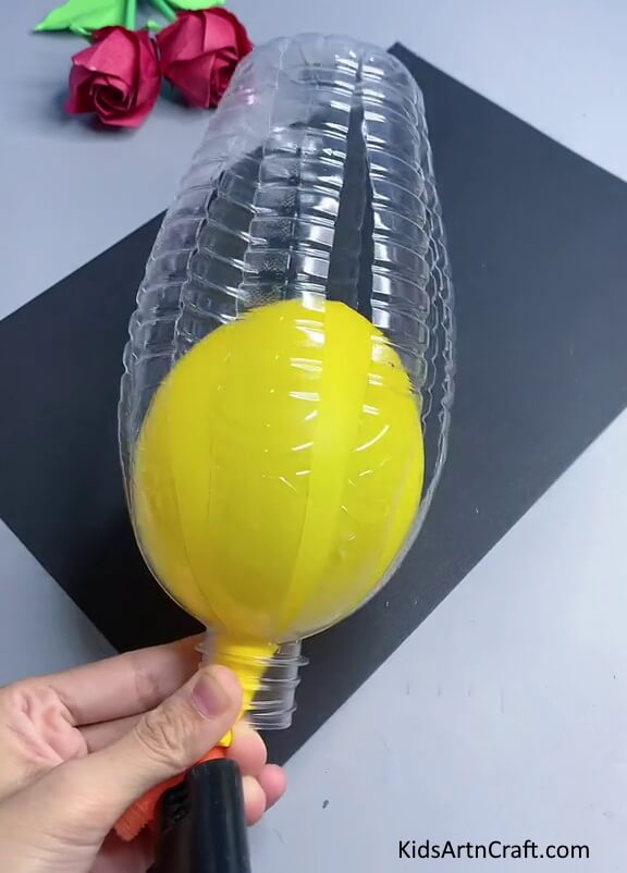 Inserting Yellow Balloon Inside The Bottle Upcycling Plastic Bottles Into Bees - A Detailed Tutorial