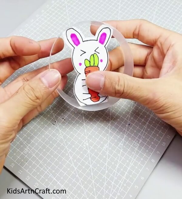 Pasting The Bunny Inside The Plastic Glass Ring - Prompt and Easy Bunny Art For Children To Produce