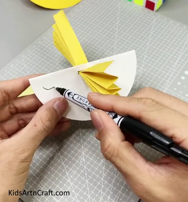 Drawing Eye Using Black Marker - Construct a Rocking Paper Bird Craft For Kiddos