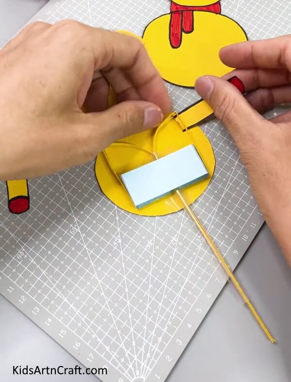 Pasting The Arm -Teach your youngsters how to make a paper snowman