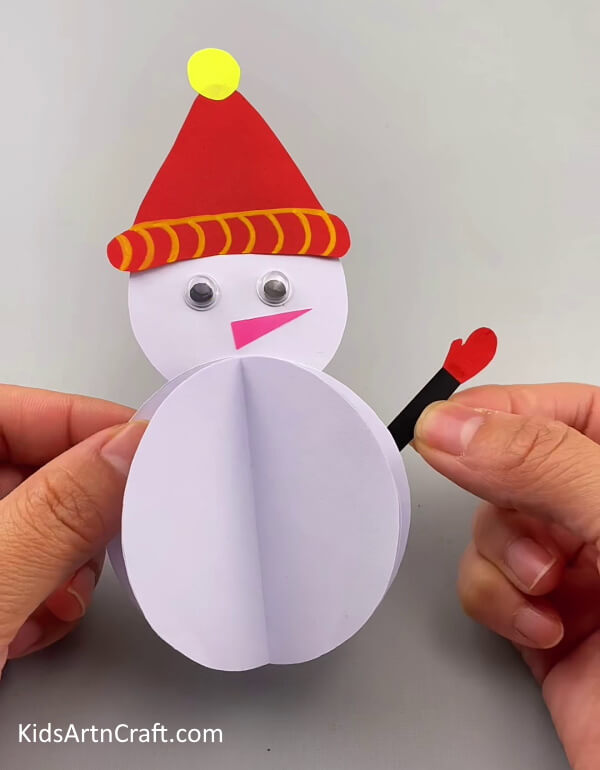 Adding hands and a nose- A Guide For Making A 3D Snowman With Paper For Kids