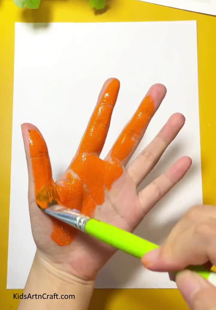 Paint one hand- A Guide to Making Handprint Fish for Novices 