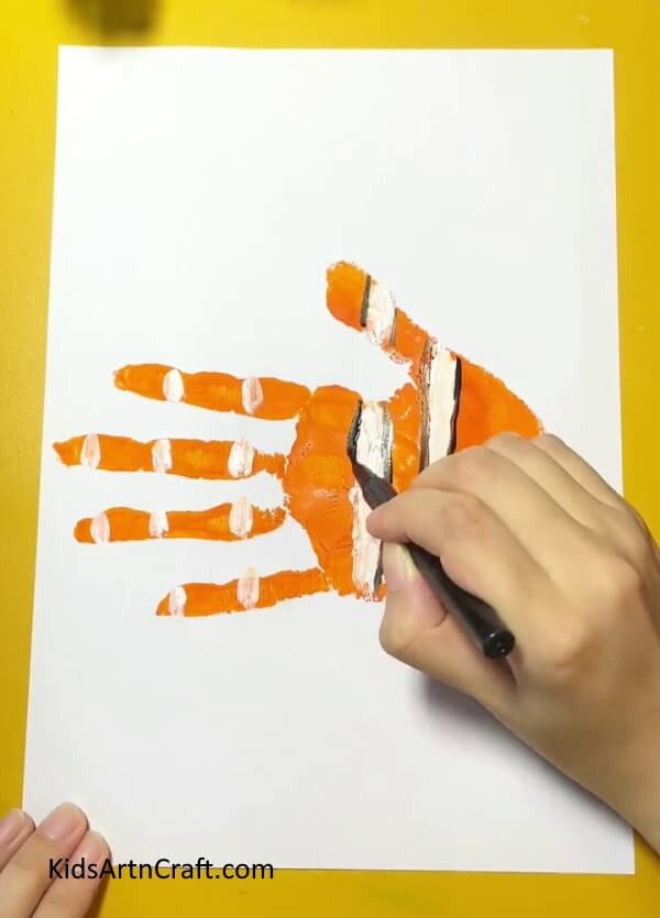Drawing outlines of the strips of fish- A Simple Walkthrough For Handprint Fish Crafting