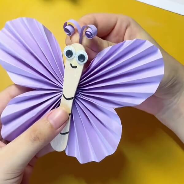 Paste The Curled Strips Behind The Popsicle-Learn How To Make A Butterfly Out Of Paper and Popsicle Sticks For Kids 