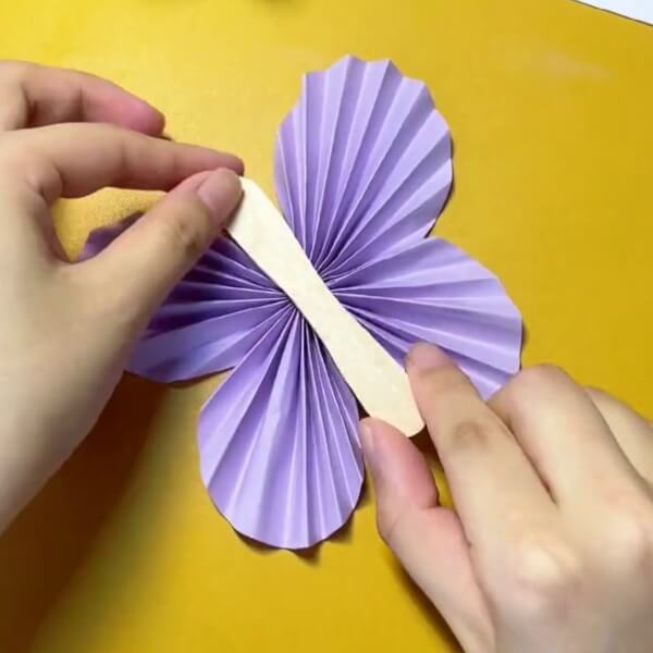 Take A Popsicle Now And Place It In The Center-A Fun Tutorial For Kids To Create A Cute Butterfly From Paper and Popsicle Sticks 
