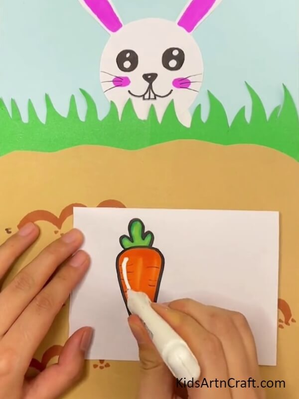 Adding Details Using White Pen Artfully Crafting a Bunny from Carrots with Assistance from Kids