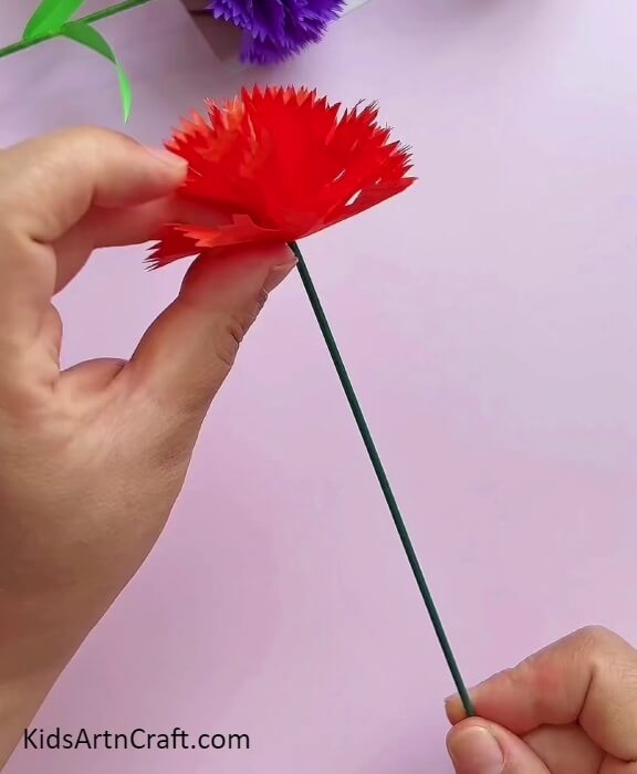 Keep Inserting the Red Petal in Green Paper Clip- Create Pretty Carnation Paper Blooms Easily With This Tutorial for Beginners
