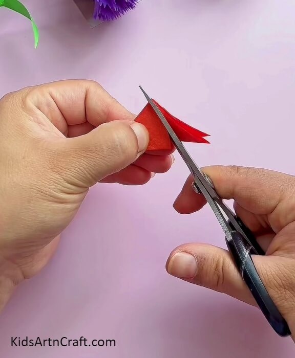 Cut Red Craft Paper Into Shape With Scissors- Create Beautiful Carnation Paper Flowers With This Beginner-Friendly Tutorial 