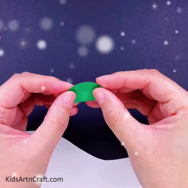Fold the circle into two halves- Pretty Christmas Tree Paper Constructions For Kids