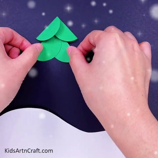 Paste the other two cutouts just below the first two- Attractive Christmas Tree Paper Crafts For Children