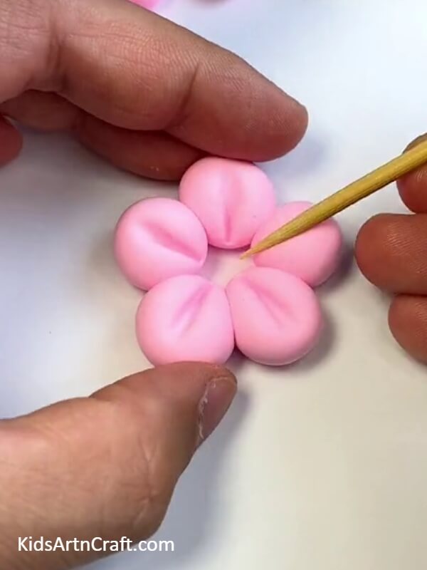 Make marks in the middle of the clay balls with tooth pick for Beautiful Flying House Balloon-How to Make a Beautiful House Balloon That Flies for Kids 