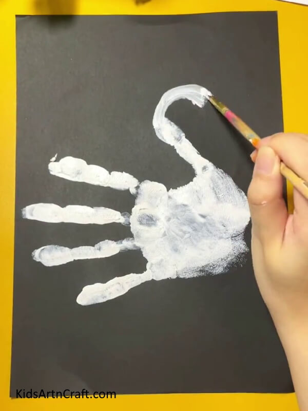 Painting the thumb further.- Lovely Handprint Swan Creation Guide For Newcomers