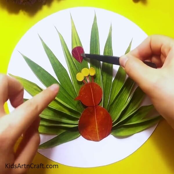 Stick red leaves with glue- An exquisite leaf peacock craft designed for kids