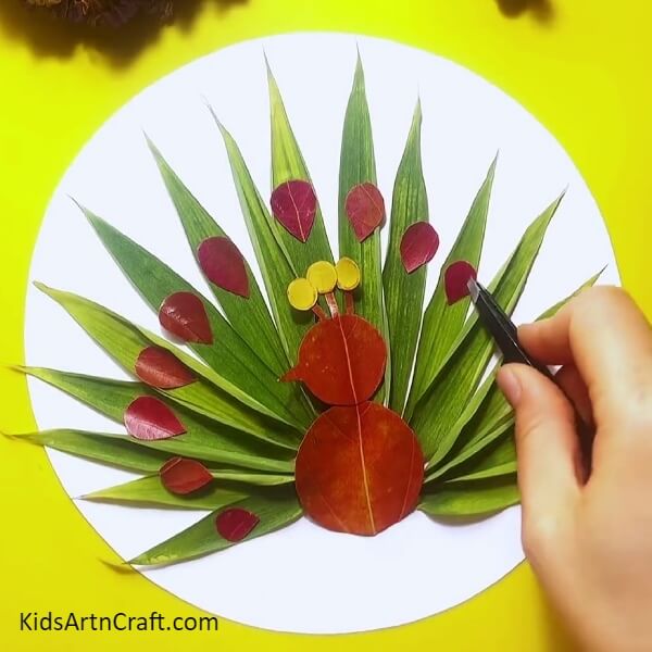 Make more small red leaves- A stunning leaf peacock activity ideal for children
