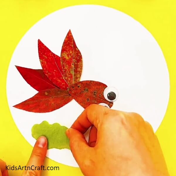 Take A Green Leaf And Give It A Cloud Shape With The Help Of A Pair Of Scissors-Best Ideas to Make Red Fish Swimming In Water Craft From Fall Leaves