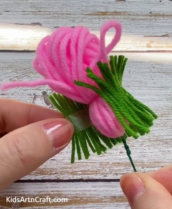 Pasting Green Woolen Thread Around Our Flower- Guide for Crafting Marvelous Wool Flowers with Kids