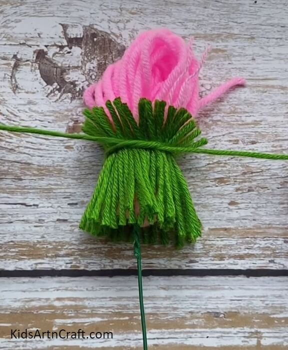 A Cutting Piece Of Green Woolen Thread- Tutorial For Designing Stunning Wool Flowers with Children