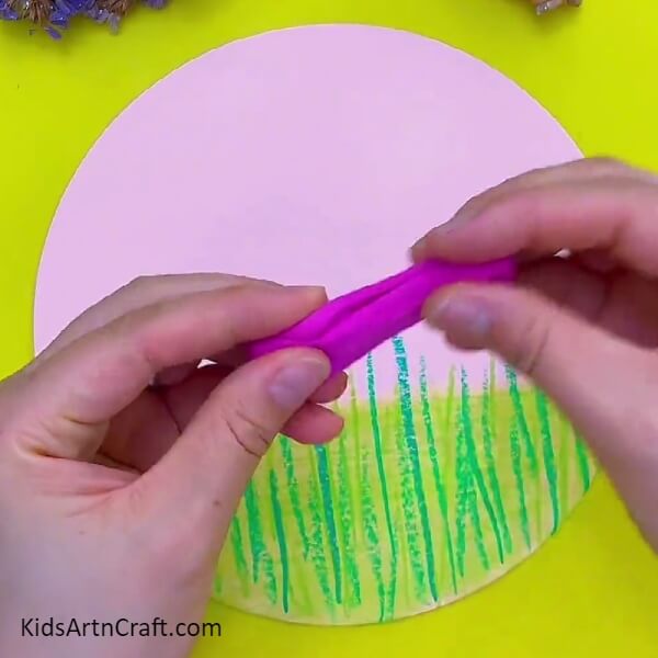 Cutting small pieces of clay from pink color clay- Tutorial to making clay flowery landscape art
