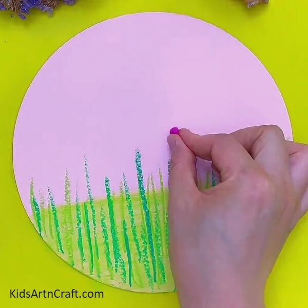 Pasting Pieces Of Clay Above Some Green Lines- Creation of flowery landscape with clay for children